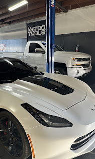 Silverado pickup and Corvette in the bay